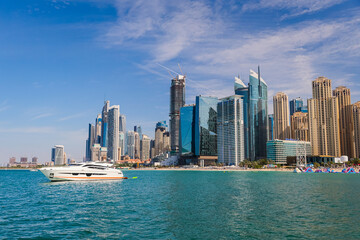 Fototapeta na wymiar Skyscrapers of the district Dubai Marina, Yacht, luxury background.