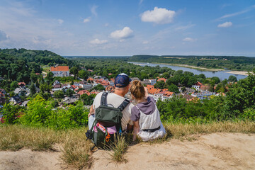 Fototapeta na wymiar Father and daughter looking at the city skyline on a sunny summer day. Kazimierz Dolny.