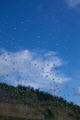 Rain drops window glass. Rainy day sky view through window