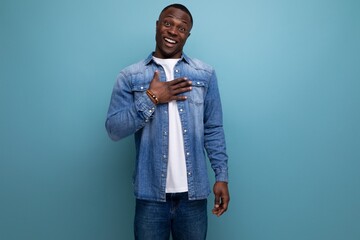 young handsome shy african guy in urban clothes on isolated background with copy space