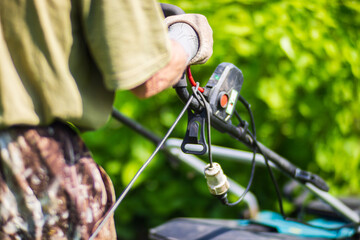 Lawn mover on green grass in modern garden or backyard. Machine for cutting lawns. Gardening care tools and equipment