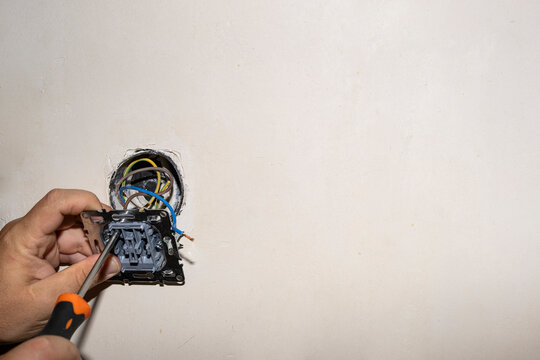 Installation of an electrical outlet in a concrete wall. Repair of the outlet. Replacement of the electrical outlet.