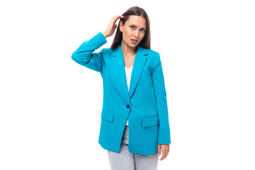 confident stylish young brunette businesswoman in a blue jacket in an image for a meeting on a white background with copy space