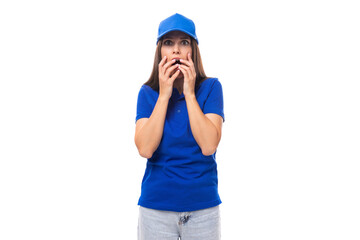 surprised pretty young caucasian brunette advertiser woman in blank blue t-shirt and cap for print illustration