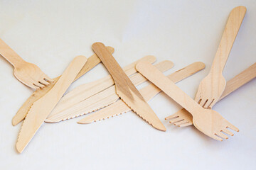 Disposable eco friendly wooden forks and knifes on white background. Eco friendly disposable wooden...