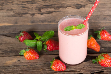 Strawberry yogurt fruit juice smoothie pink colorful fruit juice milkshake blend beverage healthy high protein the taste yummy In glass drink episode morning on wood background.