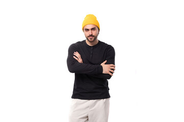 young caucasian brunette man with a beard in a casual sweatshirt stands confidently on a white background with copy space