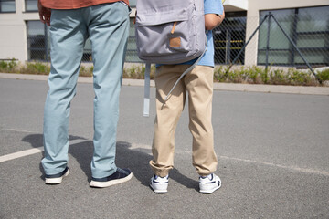 the first day of school. the father takes the boy to school. Parental care, back to school, education.