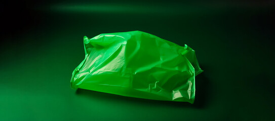 A top down view of a vibrant green plastic bag placed on a clean, solid green background, offering a simple and minimalist aesthetic. generative AI.