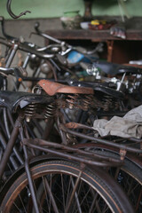 Stack of vintage rusty bicycles in the workshop