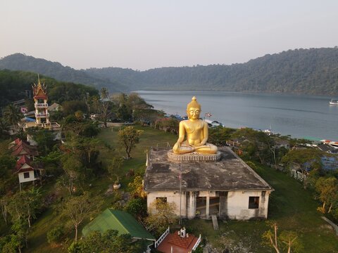 The big golden Buddha image is Luang Pho Phutthapadeep Srisathaporn.  Located at Koh Kood, Thailand