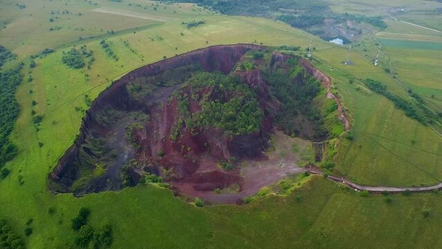 4K Aerial Drone flyover footage of the extinct Racos Volcano. Dormant Volcano with lush vegetation in summer.