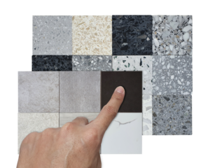 architect's hand selects multicolored and texture of square shapes terrazzo artificial stone samples and porcelain ceramic stone tile samples isolated on background with clipping path.
