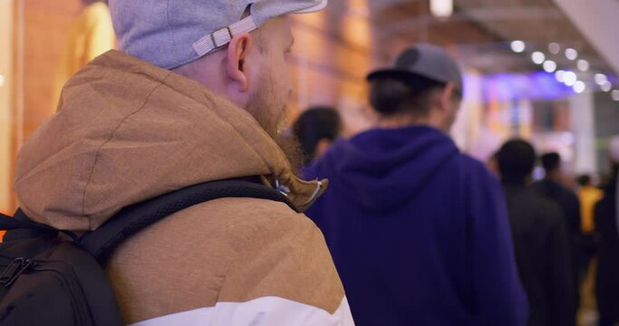 Tired people in long queue waiting their turn to buy stuff. Dynamic video of long queue of people at evening time in mall center. Make shopping online or come to mall center earlier to avoid queue.