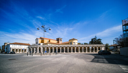 Fototapeta na wymiar Tresigallo Italy church and portico - littorio style urban architecture