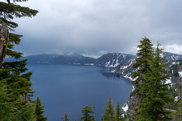 Looking over the rim into the Caldera of a volcano at Crater Lake National Park in Oregon on a stormy day.