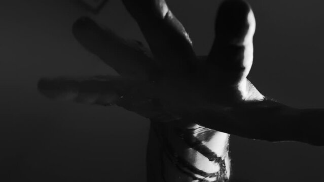 Hand of a man bleeding to death, black and white video