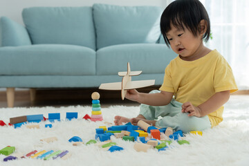 Happy Asian child playing and learning toy blocks. children are very happy and excited at home. child have a great time playing, activities, development