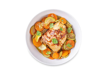 Moroccan spiced chicken with zucchini and carrots in a plate on a white isolated background