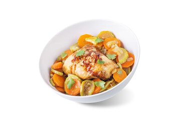 Moroccan spiced chicken with zucchini and carrots in a plate on a white isolated background