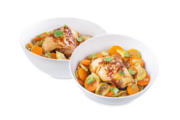 Moroccan spiced chicken with zucchini and carrots in a plate on a white isolated background