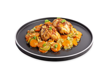 Moroccan spiced chicken with zucchini and carrots in a plate on a white isolated background