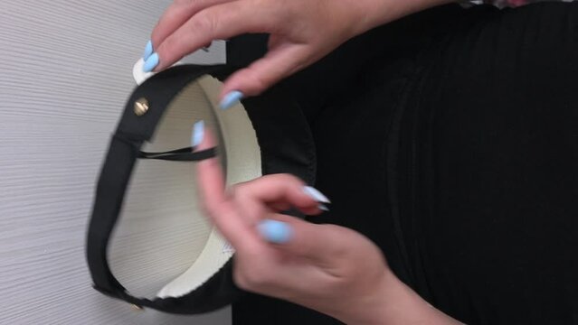 Visor for protection from the sun. The blogger makes a review. Showing off the cap. vertical video