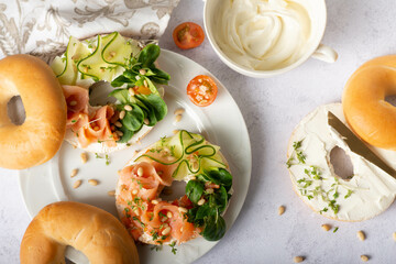 Food, lunch, brunch, meal on a plate, plating concept. Bagels with smoked salmon, cream cheese and...