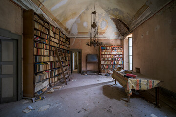 library of abandoned building with books and dust