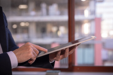 business and technology concept, social media working and life styles, businessman using digital tablet searching surfing on internet network, data analysis business online report