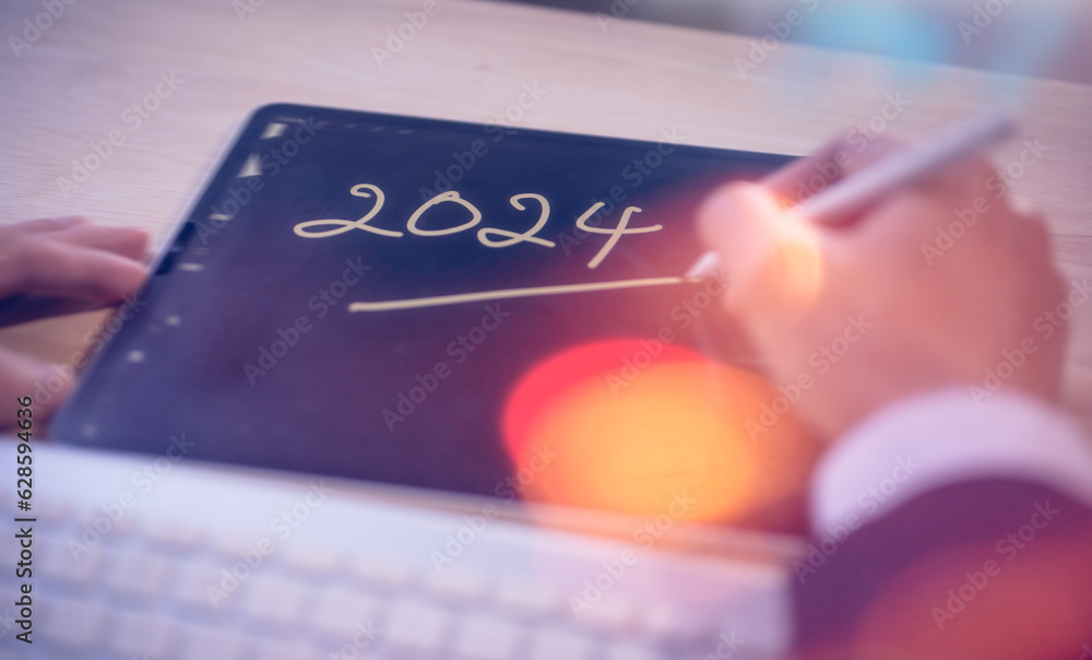 Aufkleber concept for financial planning and reminder for 2024. man using digital tablet or smartphone working