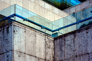glass railing and balustrade over stone parapet. balcony guard rail. laminated tempered safety...