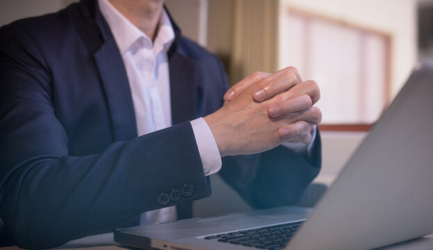Hands of a thoughtful, hr recruiter making hiring decision at difficult job interview, opponents dialogue debate, business confrontation challenge concept, pray hope and negotiation business dealing
