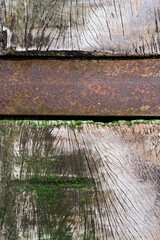 Rough surface of a wooden wall with a rusty metal bar, Belgium
