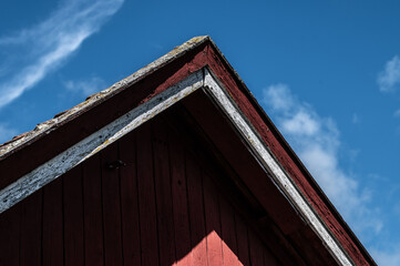 Fototapeta na wymiar Red barn roof and blue sky
