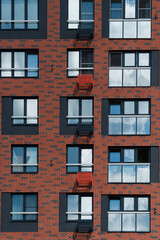 the brown facade of a new residential apartment building in Scandinavian style