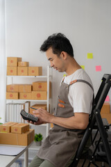 Start SME, small business entrepreneurs, SMEs of freelancers. Close-up shots of Asian women using smart phones and laptops with boxes. Online Marketing and SME Delivery Ideas.