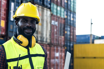 portrait black container worker man with stack of containers in shipping cargo