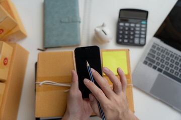 Starting small businesses SME owners, two check online orders Selling products working with boxs freelance work at home office using tablet and laptop marketing, packaging, concept