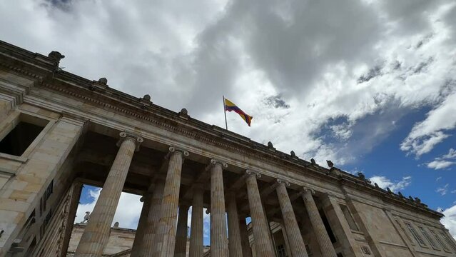 facade of the Senate of the Republic of Colombia with the flag waving in the center of Bogotá