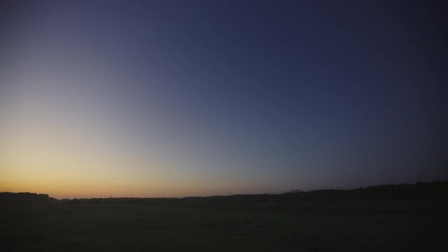 Airplane Passing Overhead Before Dawn On Approach To Airport