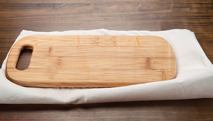 Empty wooden cutting board on a white tablecloth on a wooden background