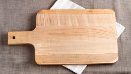 Wooden cutting board on a table cloth. Top view with copy space.