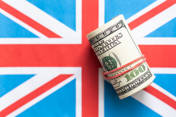 Money over the United Kingdom flag. Criminal, crime and corruption concept. UK outlaw and social...