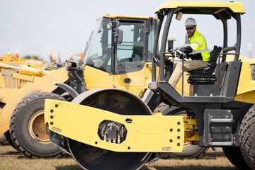 busy worker man in construction equipment. construction worker drive heavy machinery for roadwork....