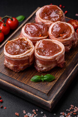Delicious raw fresh pork or chicken meat rolls wrapped in bacon