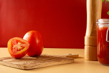 Fresh sliced tomatoes in a red background in front view