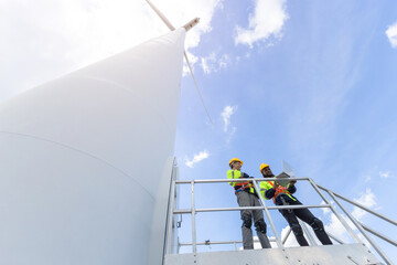 Wind turbine engineer technician male team working service maintenance survey construction site. Eco power energy generator for sustainable people worker.