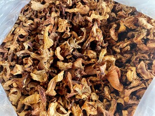 Background of dried edible mushrooms on the market closed up top view. White mushrooms dried for a sale.