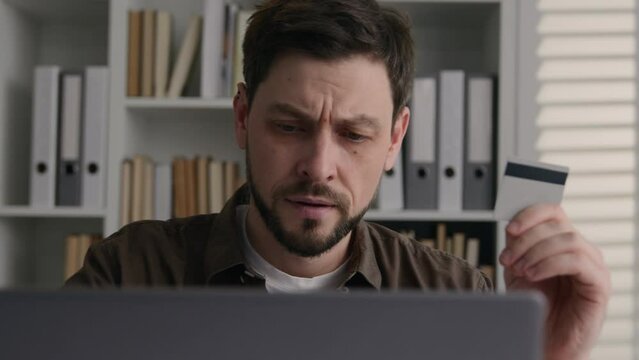 Anxious Caucasian businessman business client office employer upset man pay online on laptop rejected credit card limit problem with internet e-banking fail transaction error not enough money balance